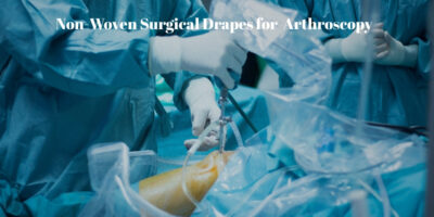 Fluid collection pouch integrated in non-woven surgical drape for shoulder arthroscopy